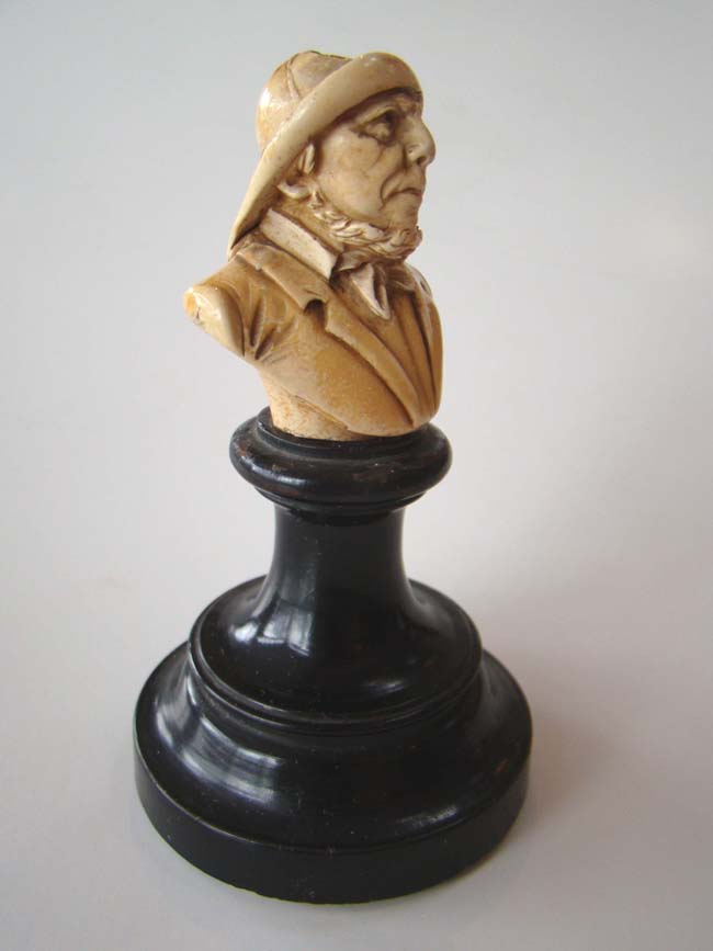 A small and charming ivory or bone bust of a fisherman mounted on a stand circa 1880